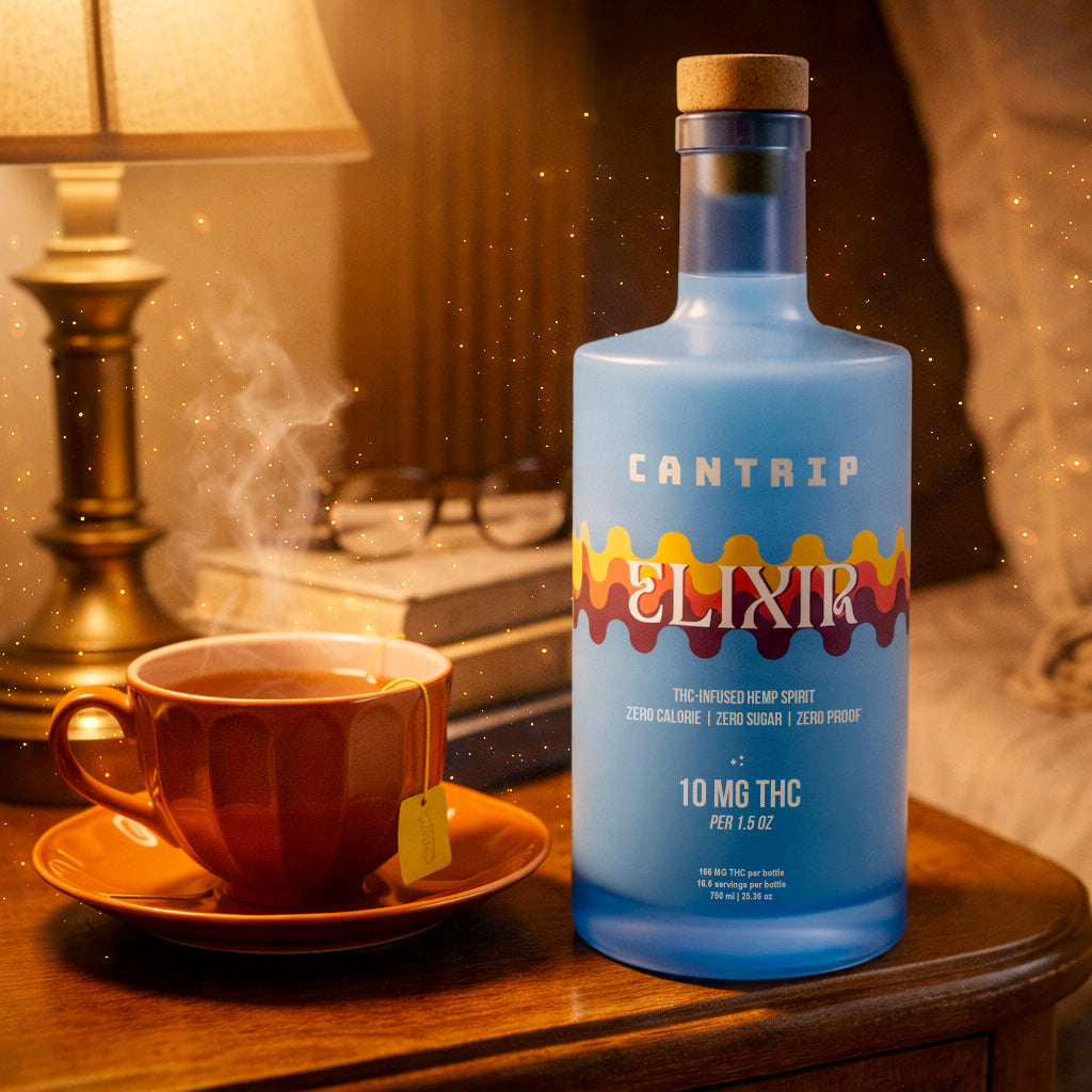A blue bottle of Cantrip Elixir, a THC-infused hemp spirit, placed next to a steaming cup of tea on a bedside table.