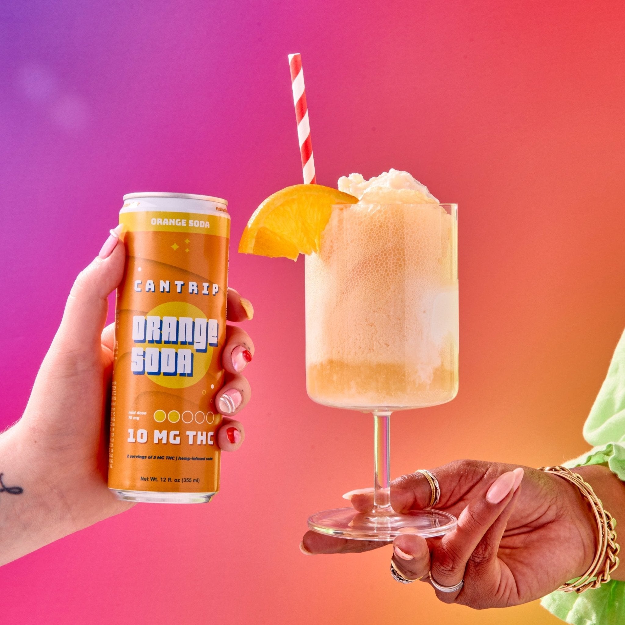 A hand holding a Cantrip THC orange soda can. Another person's hand holds an orange soda float garnished with an orange slice.