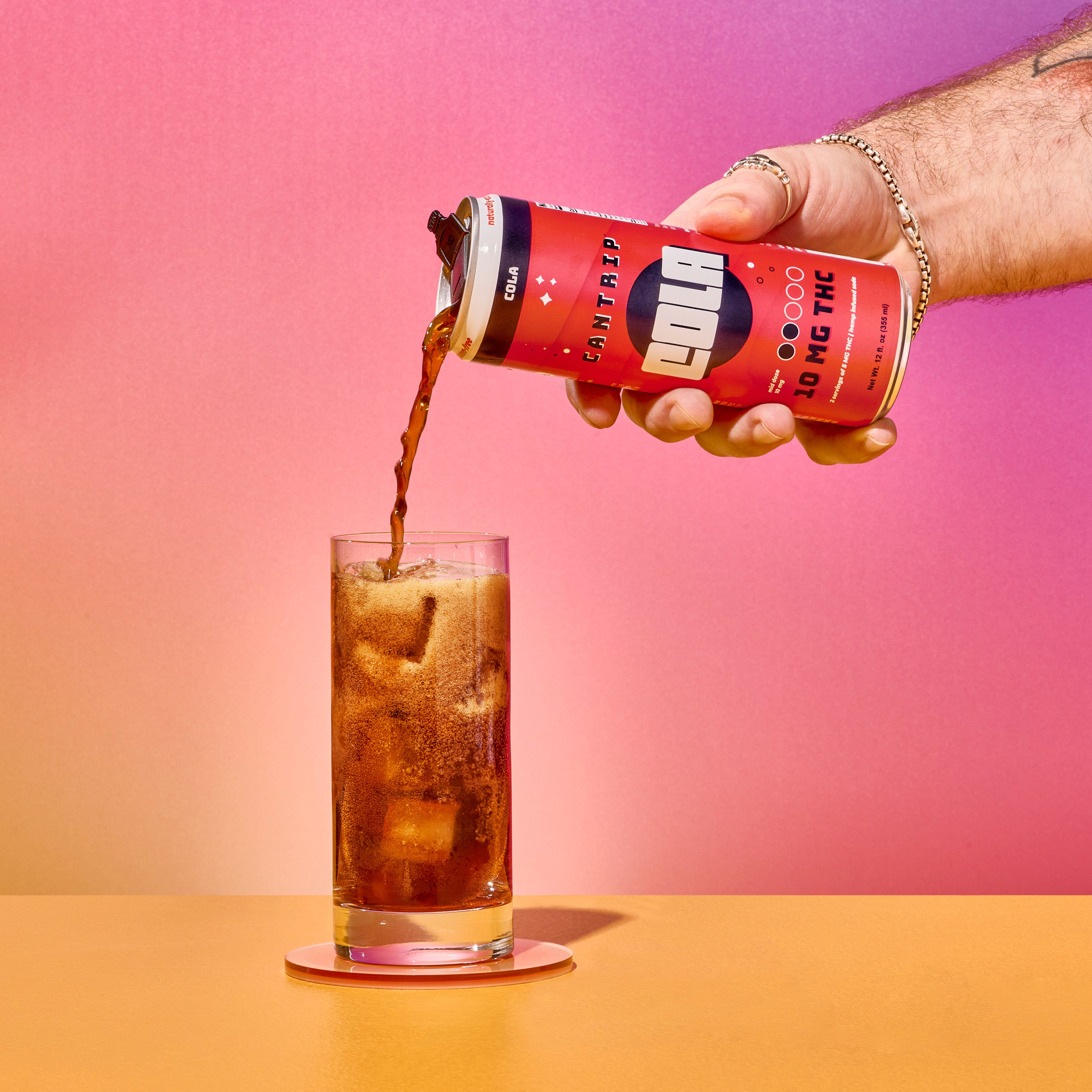 A can of Cantrip's THC-infused Cola being poured into a glass with ice. 