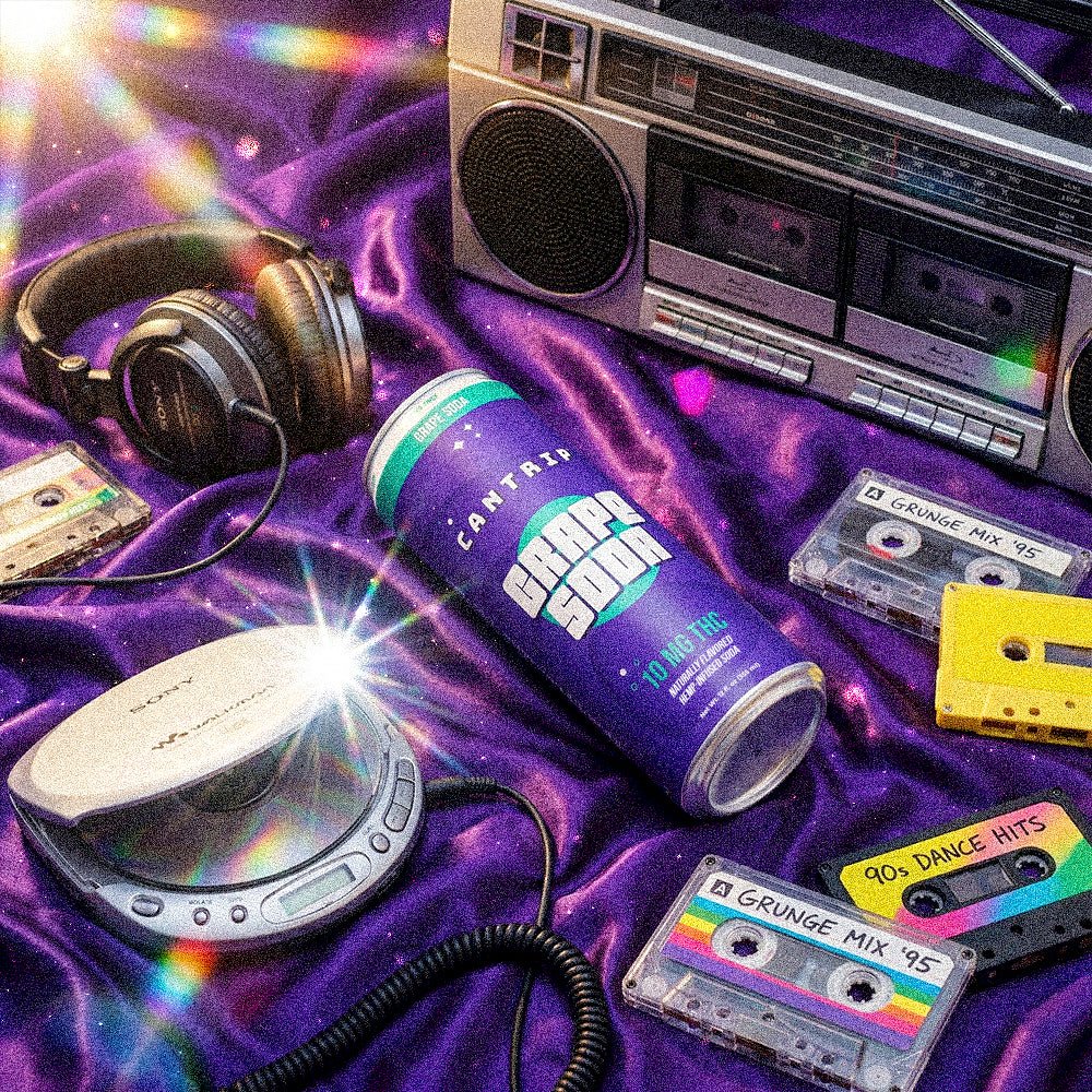 Cantrip Grape Soda THC can surrounded by a boombox, cassette tapes, headphones, and a CD player on a purple fabric background