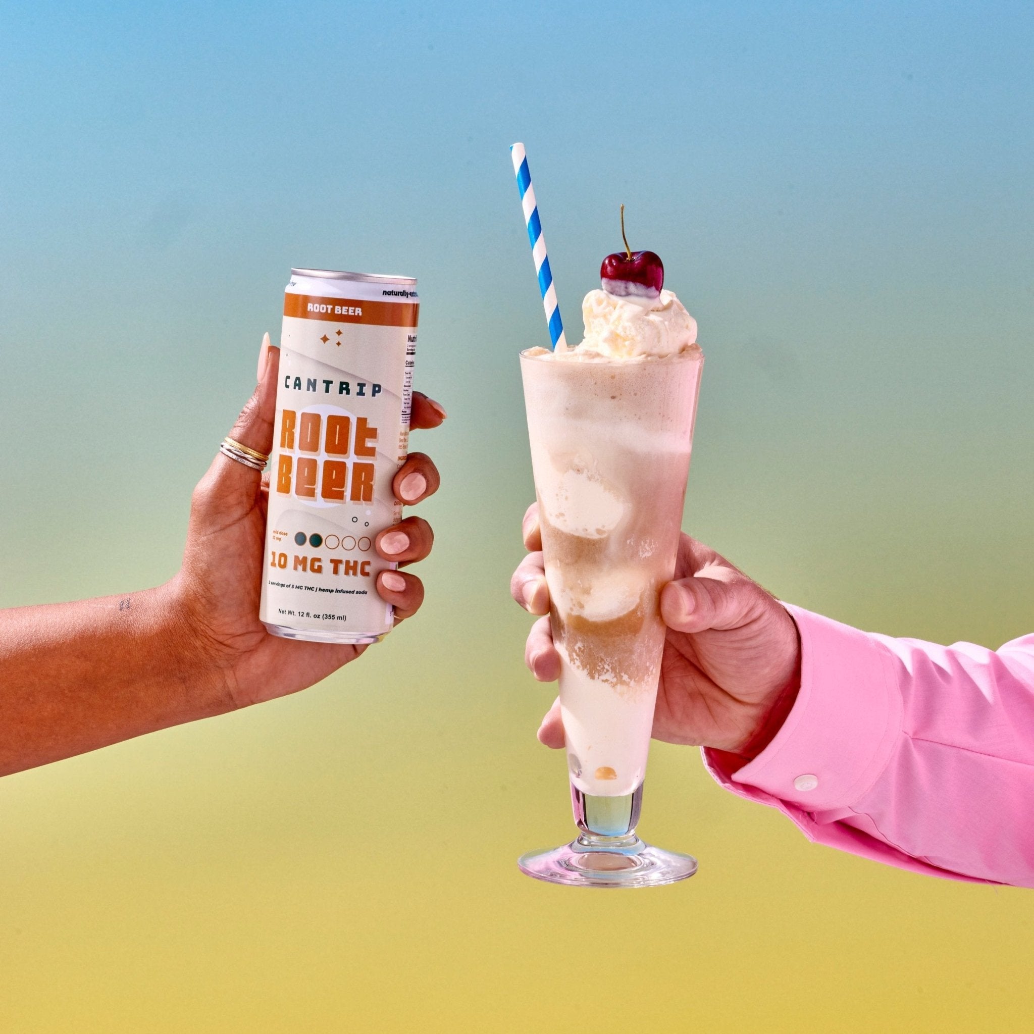 One hand holding a root beer float, made with Cantrip THC Root Beer and topped with a cherry. A blue and white straw has been inserted into the ice cream drink. Another hand holds a cream-colored can of Cantrip 10 MG THC Root Beer.